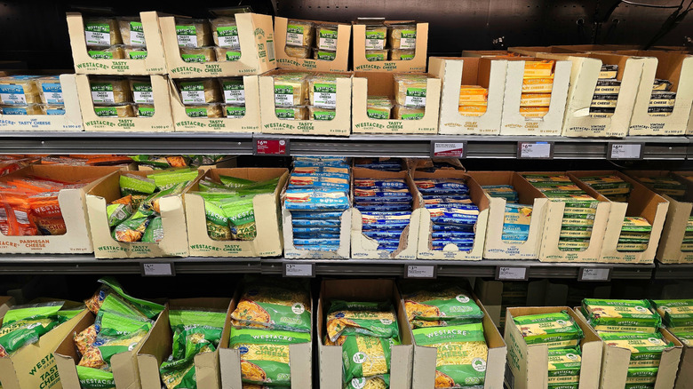 Various cheeses in boxes on the shelf at an Aldi