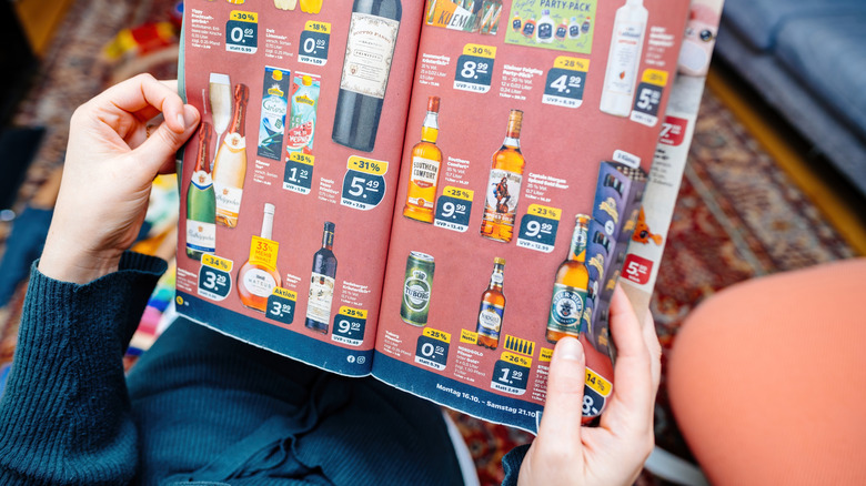 A person reads a German Aldi weekly deals paper