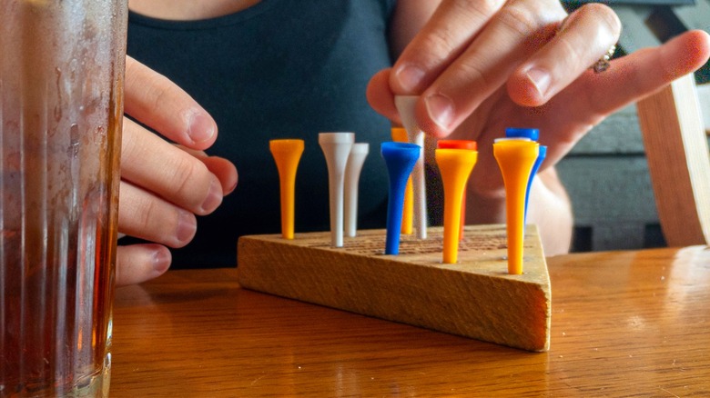 A person plays a classic peg game