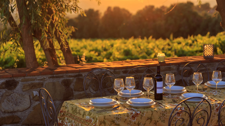 Set dining table overlooking Tuscan vineyards