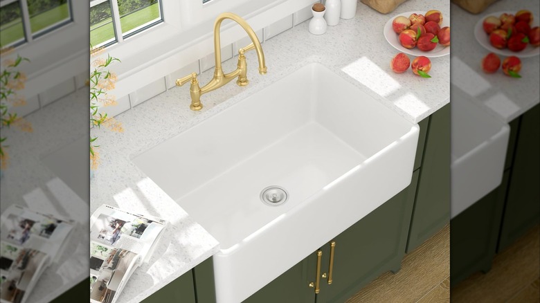 white basin sink with gold faucet