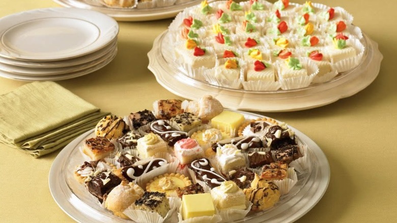 Two platters of Publix mini desserts on a yellow table