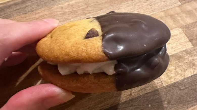 A handing holding a mini yo-yo cookie from Publix