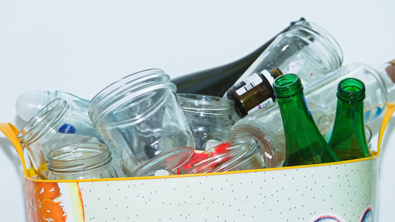 A bin full of glass containers and bottles, separated for recycling