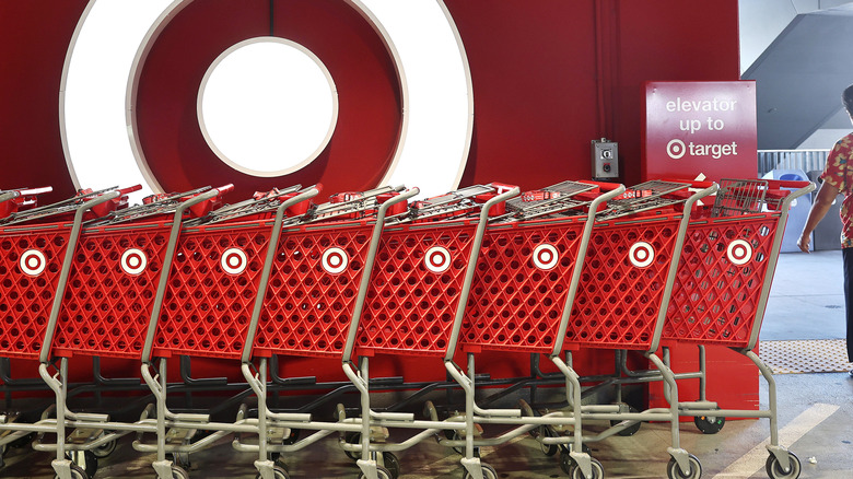 Target shopping carts lined up in front of the store logo