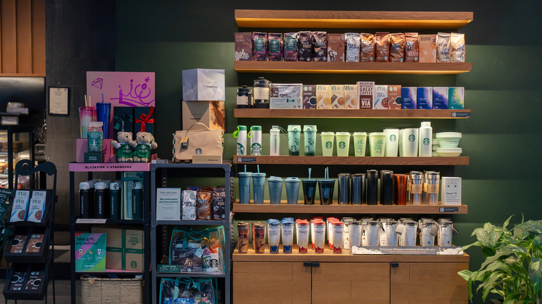 Shelves of cups, mugs, and other merchandise at a Starbucks coffee shop