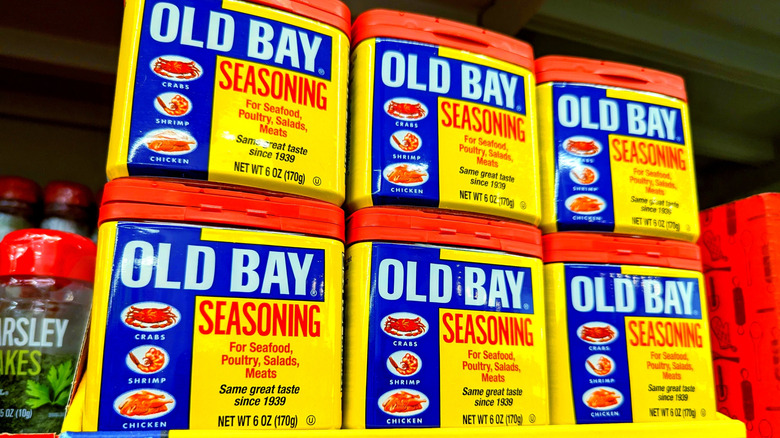 Several cans of Old Bay Seasoning lined up together on a store shelf