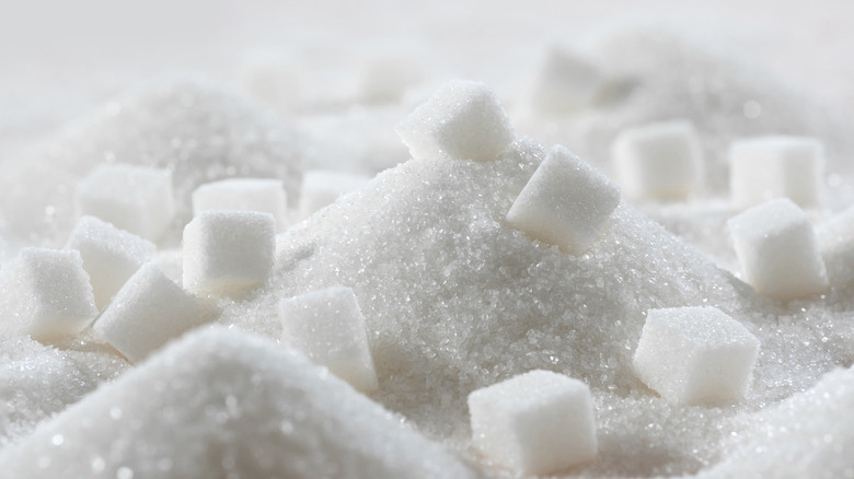 A pile of white sugar with cubes in it