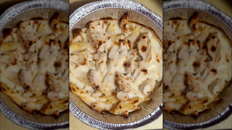 Domino's Chicken Alfredo Pasta in a foil takeout tray