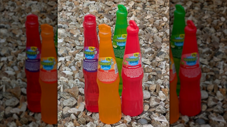 Four bottles of SqueezIt juice on the ground.