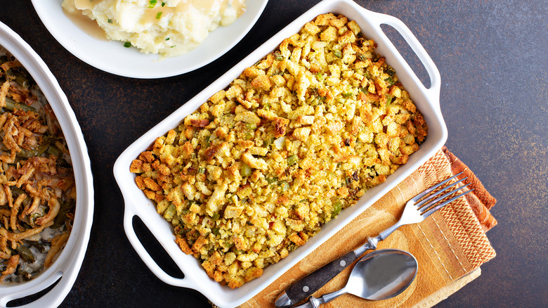 Person holding sheet pan with checkered cloth