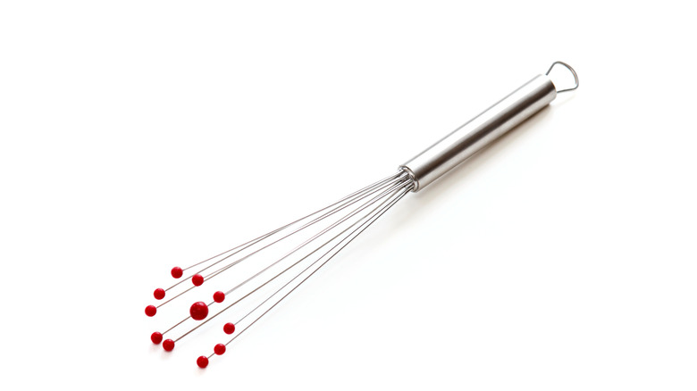 Whisk with red spheres
