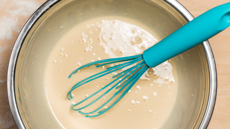 Blue whisk in batter bowl