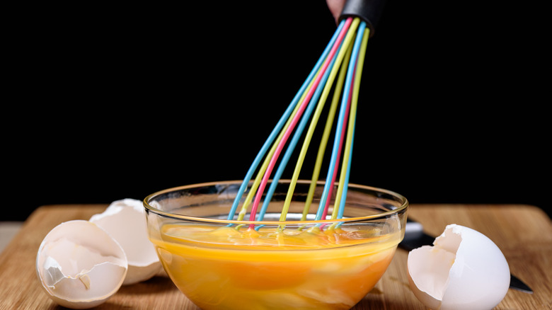 Colorful whisk in deep mixture