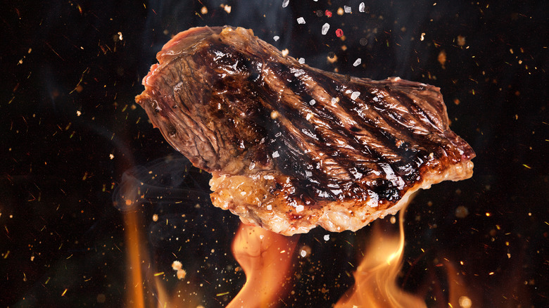 cooking meat over fire