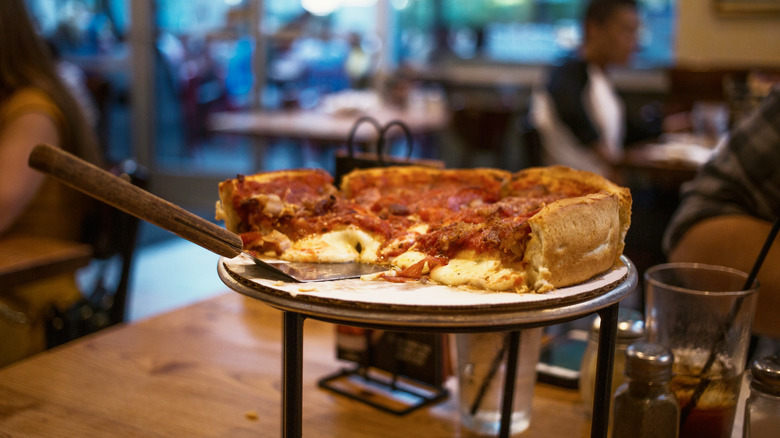 deep dish pizza on stand