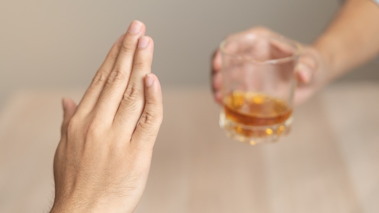 Hand refusing a drink