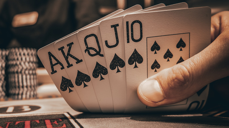 hand of cards showing a royal flush