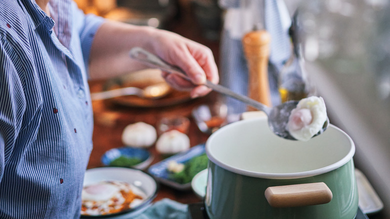 Person poaching eggs