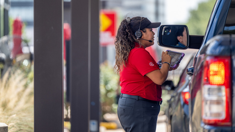 an employee working at a drive thru