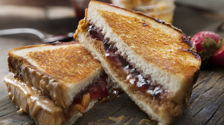 peanut butter and jelly sandwich on wooden table