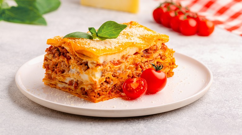 Lasagna on a plate with tomatoes