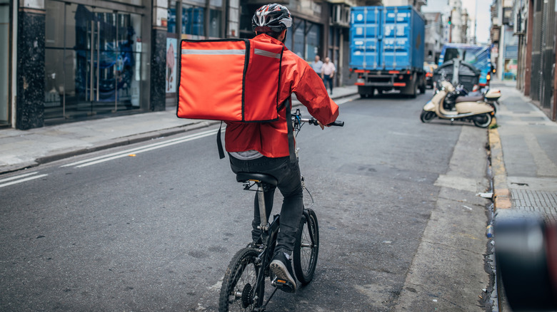 person on bicycle delivering food