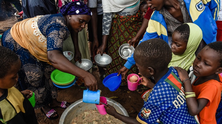 Children in Tanzania wait for food