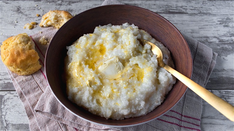 Cooked grits in bowl with butter 