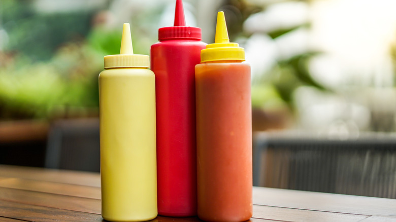 Several bottle of condiments on outdoor table