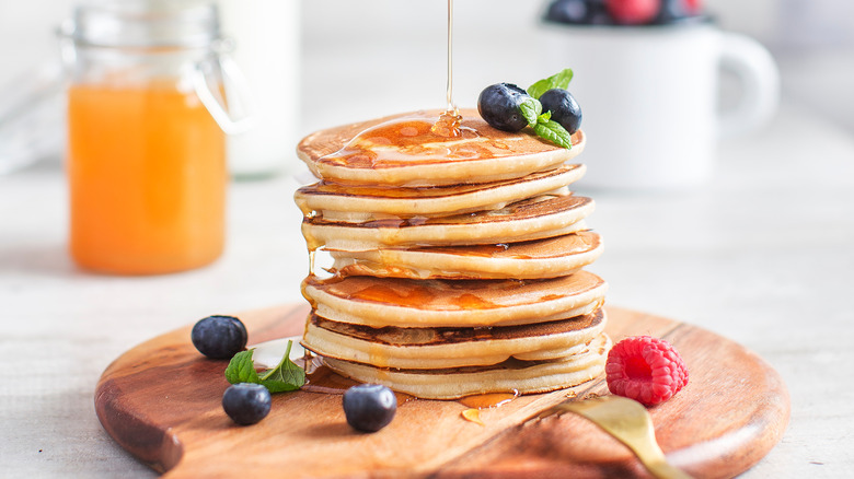 Stack of pancakes drizzled with honey