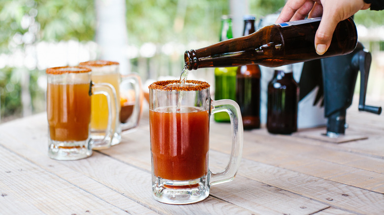 Beer being poured into a michelada