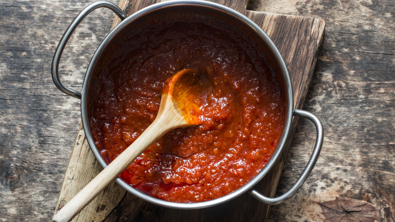 tomato sauce with wooden spoon