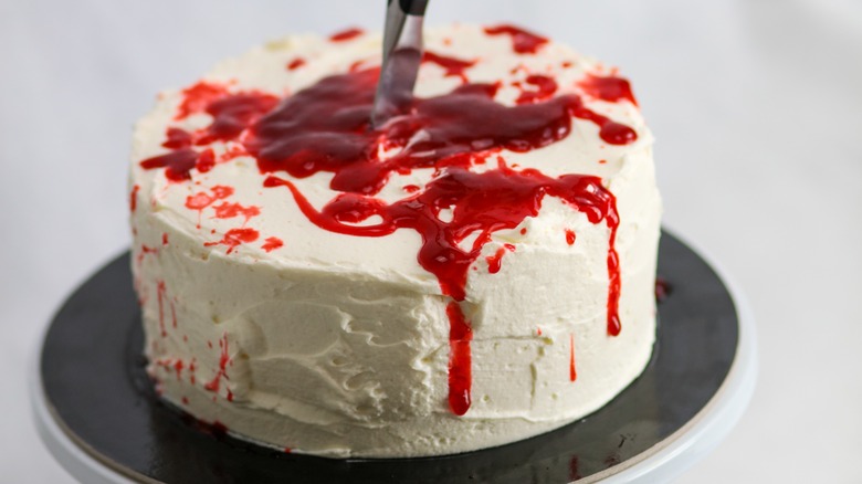 Cake with red sauce and knife