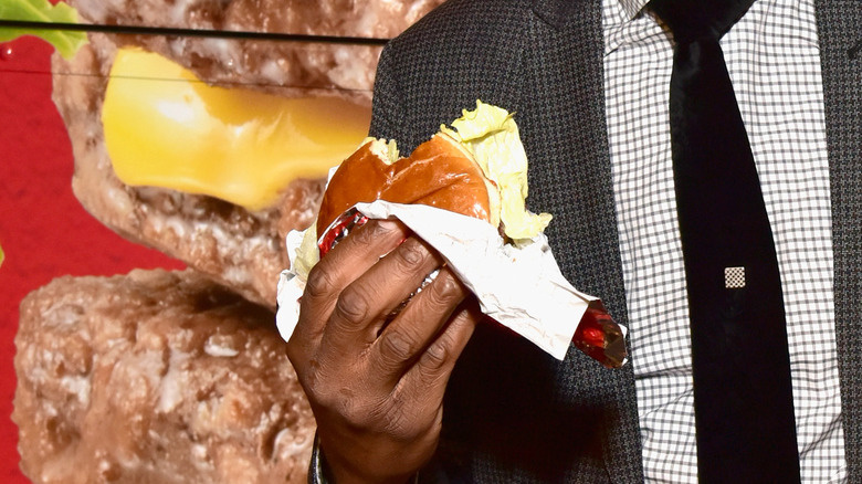 Man holding a Wendy's burger