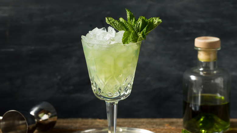 Glass of absinthe with herbs