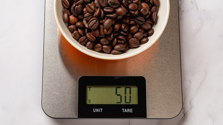 Coffee beans in a dish on a scale