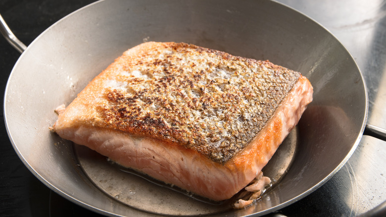 salmon filet with crispy skin in a pan