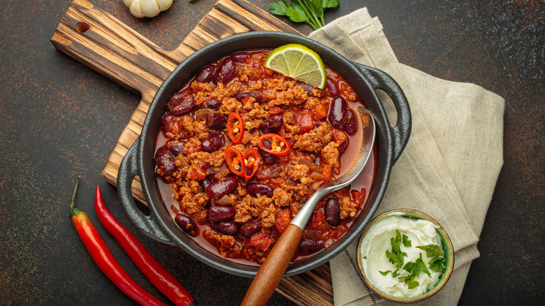 A pot of chili con carne with a serving spoon