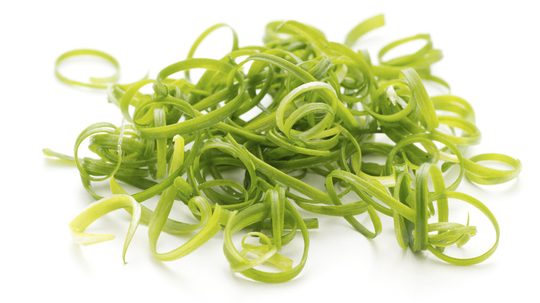 Curly scallions on white background