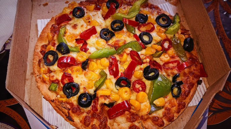 A Domino's pizza covered in vegetables