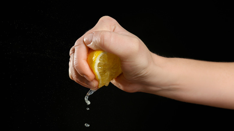 person squeezing a lemon