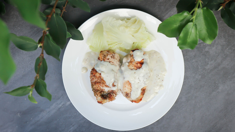 Barbecued chicken covered in white barbecue sauce