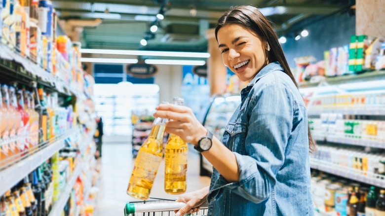 Woman winking while buying beer