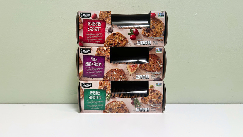 Savoritz Artisan Crisps boxes stacked in front of light green wall