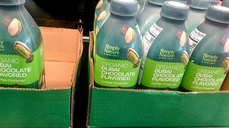bottles of Simply Nature Organic Dubai Chocolate Flavored Creamer in cardboard boxes at Aldi