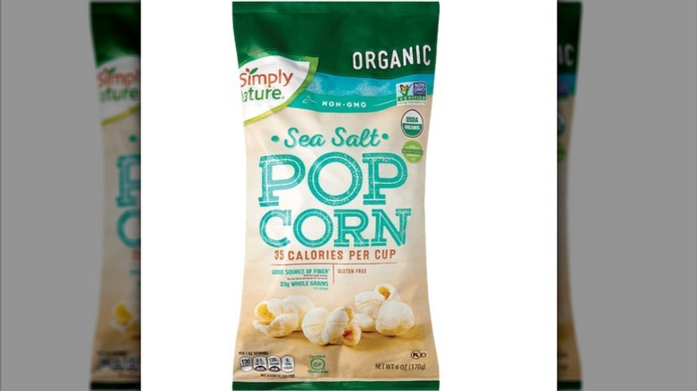 a bag of Simply Nature Sea Salt Popcorn against a white background.
