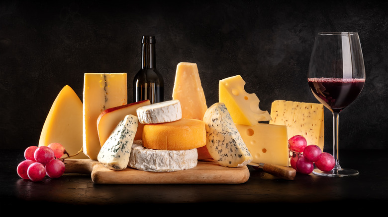 Selection of cheeses with glass of wine