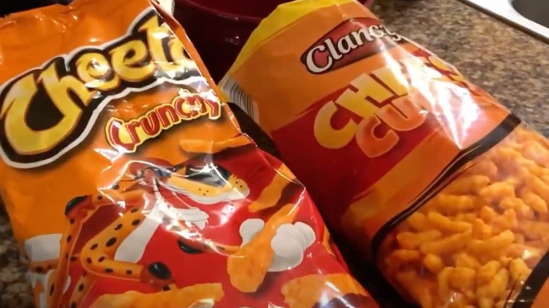 bag of cheetos and bag of clancy's cheese curls on counter