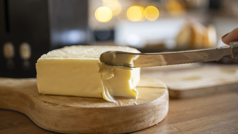 Block of softened butter and a butter knife